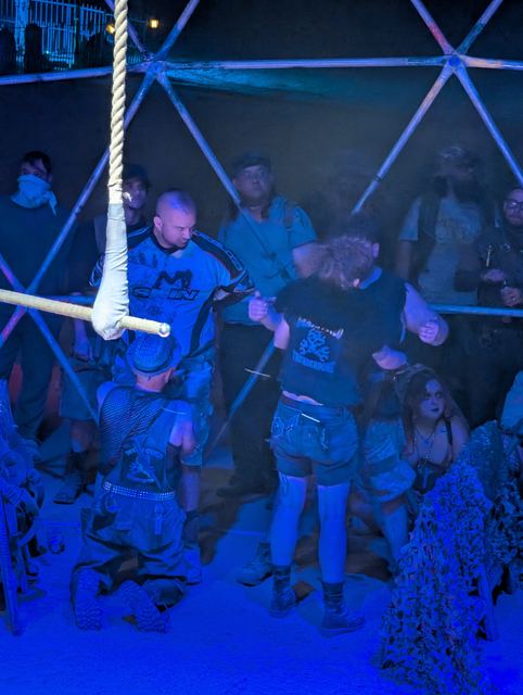 Fighters circle under the rigging, the crowd packed against the bars.